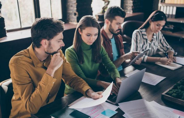 portrait-four-nice-attractive-focused-professional-people-it-recruiters-meeting-min portrait-four-nice-attractive-focused-professional-people-it-recruiters-meeting-min
