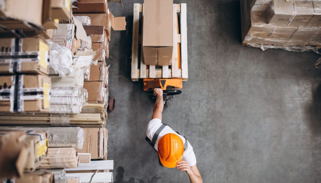 young-man-working-warehouse-with-boxes-min
